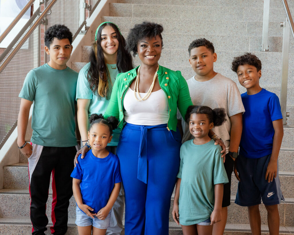 KaTrina Griffin standing with a group of kids inside