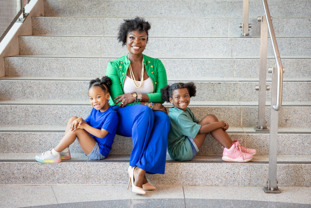 KaTrina Griffin sitting on stairs with two kids