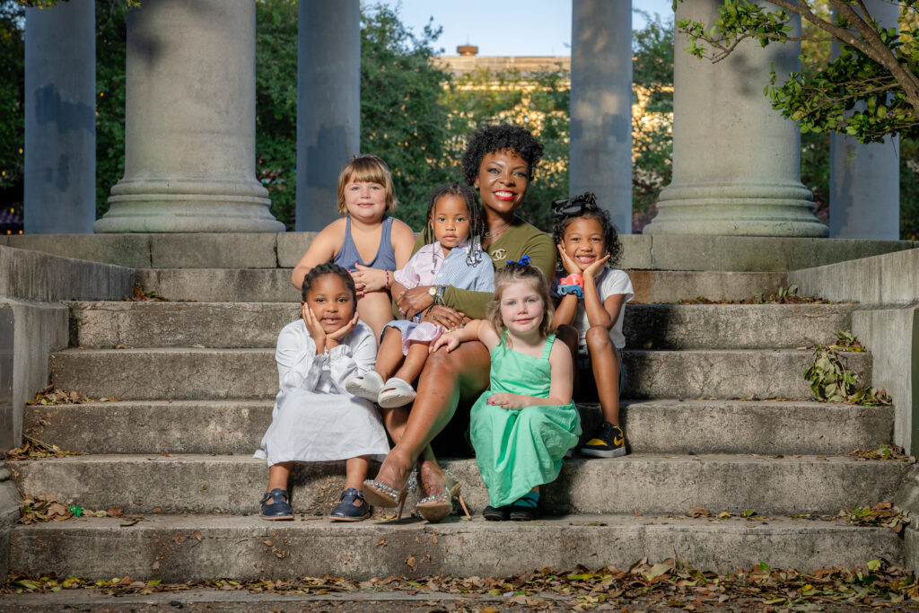 KaTrina Griffin standing with a group of kids inside